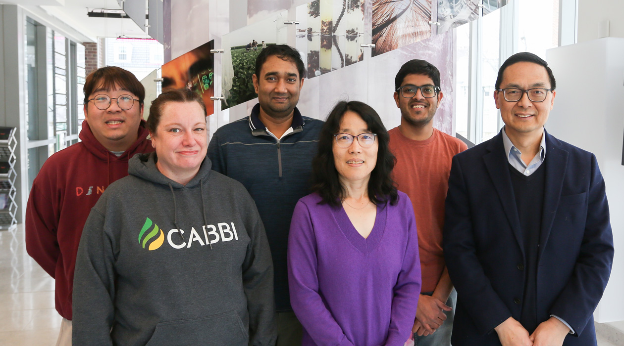 Photo of Huimin Zhao with four members of the research team