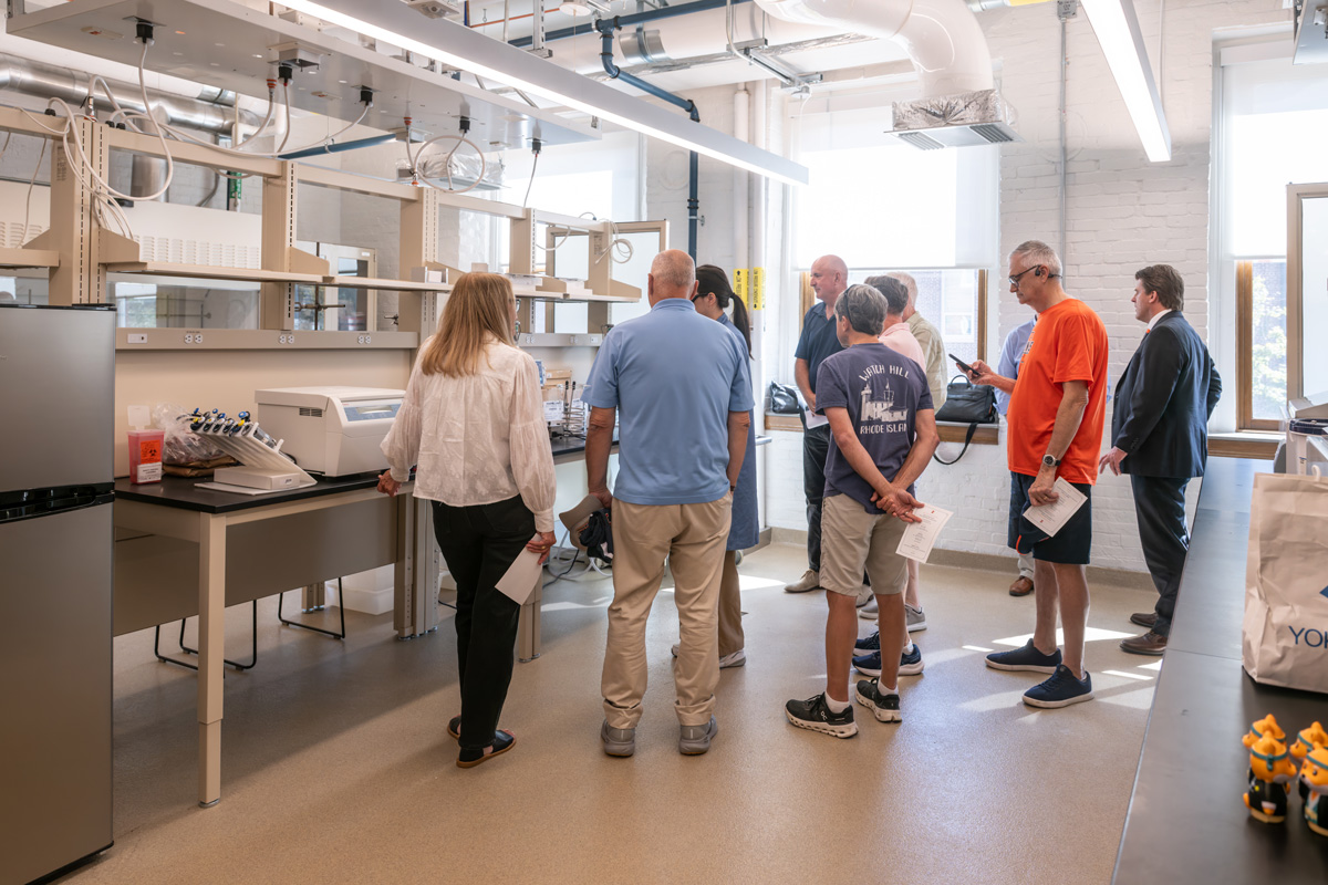 group of people looking at lab equipment