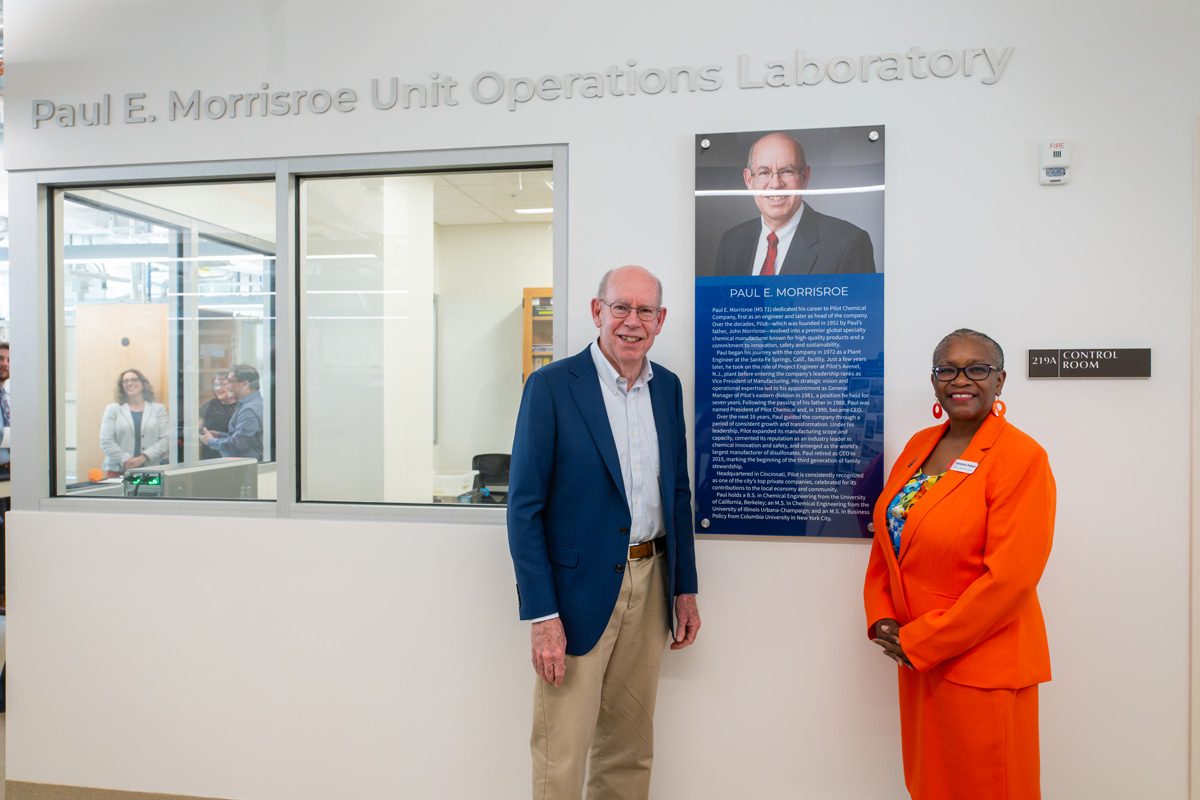 man in a dark suit and a woman in an orange dress