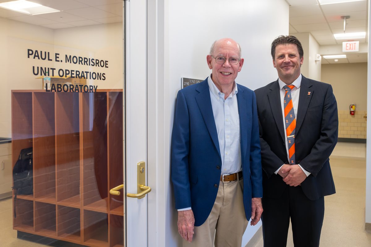 two men standing in front of the entrance to the lab