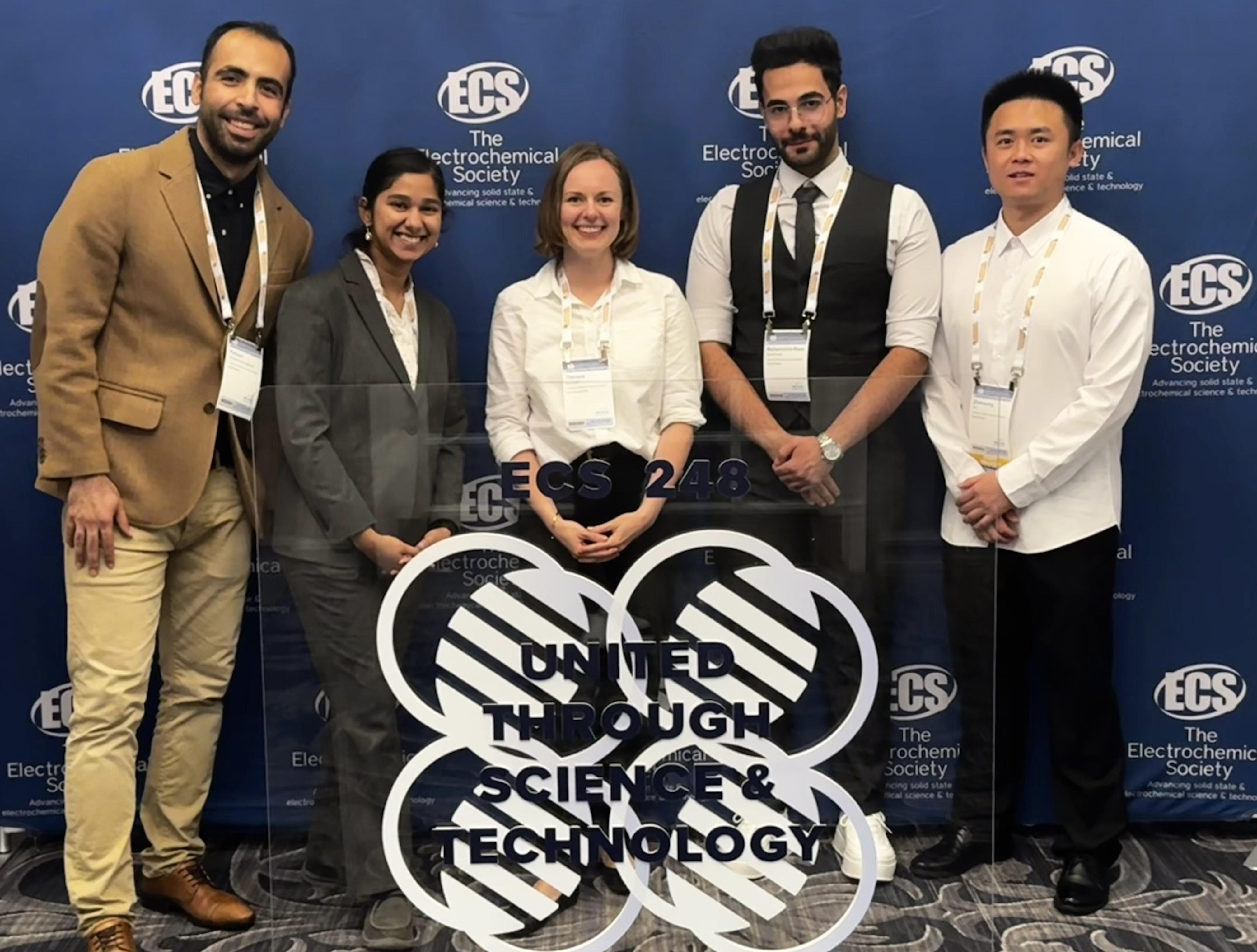 PhD students standing with Theresa Schoetz