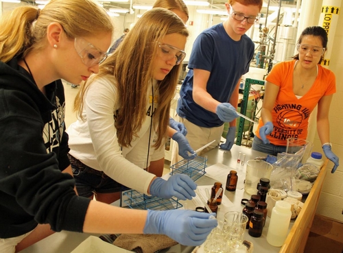 Graduate student Danielle Mai (at right) instructs students.