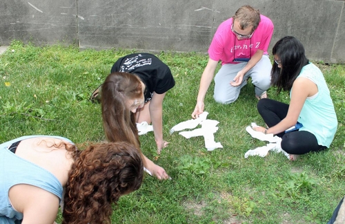 Students put grass stains into fabric