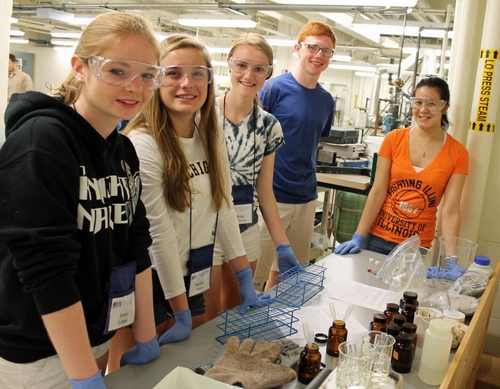 Graduate student Danielle Mai (at right) works with a group of students.