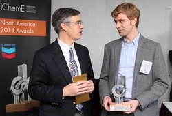 Chevron Oronite president and IChemE past president, Des King, presents Andrew Ferguson with the Young Chemical Engineer of the Year Award.