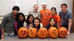Members of OXE participate in the group's annual pumpkin carving night.