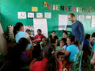 University of Illinois studentsâ€…encourageâ€…mothersâ€…inâ€…Lasâ€…Queseras Hondurasâ€…toâ€…learnâ€…aboutâ€…properâ€…hygieneâ€…andâ€…sanitationâ€…toâ€…protectâ€…theirâ€…childrenâ€™sâ€…healthâ€…duringâ€…aâ€…meetingâ€…inâ€…theâ€…villageâ€…school. 
