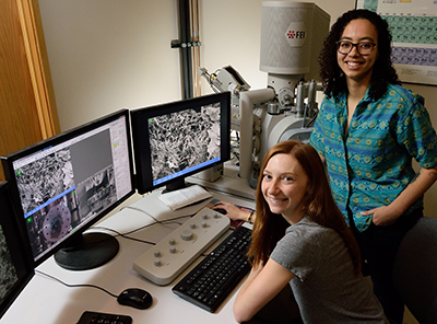 Marley Dewey, left, and Aleczandria Tiffany examine how 3D-printed biomaterials can be used to reinforce the mineralized collagen scaffold with the help of the electron scanning microscope in the Microscopy Suite of the Beckman Institute for Advanced Science and Technology.