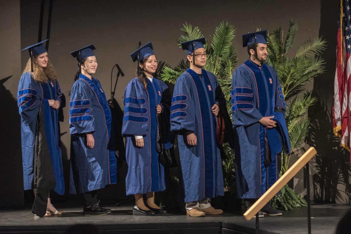 PhD candidates line up as they enter the stage for the Chemical and Biomolecular Engineering convocation on May 12, 2019.