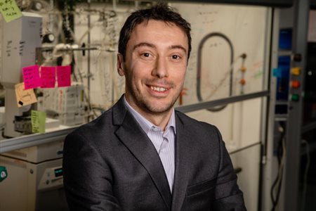 A head and shoulders picture of Damien Guironnet pictured in a lab wearing a suit.