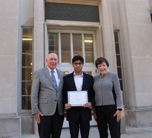 Jim and Pamela Grant with scholarship recipient Vivek Vermani standing outside the Roger Adams Laboratory.
