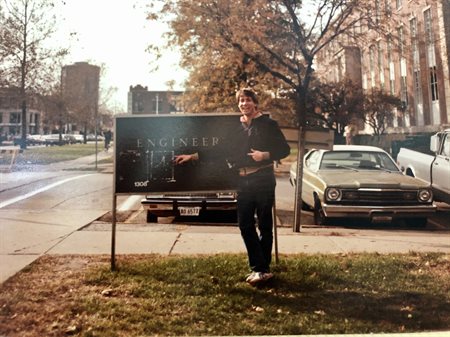 Kenneth Jaconetty covers up &quot;Hall&quot; on the Engineering Hall sign; the photo was staged by his friend and fellow Illinois graduate Scott Reed.