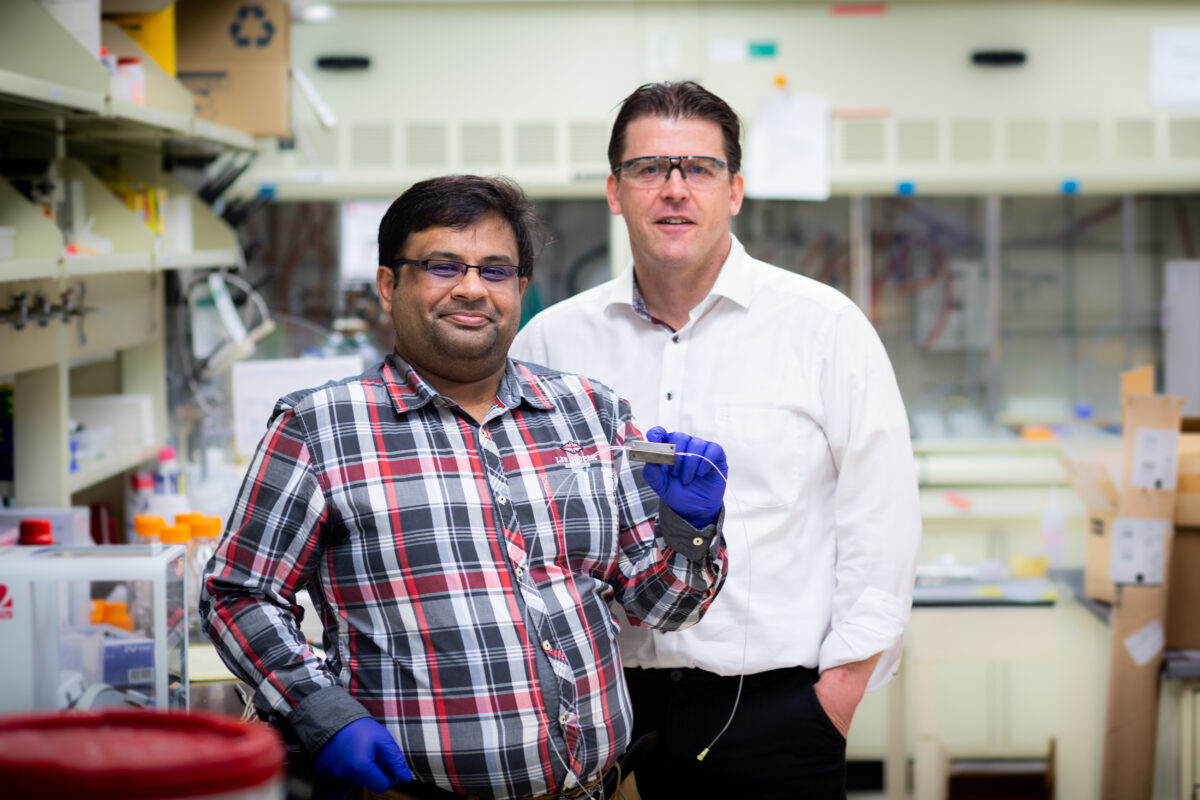 Chemical and biomolecular engineering professor and department head Paul Kenis (right) and graduate student Saket Bhargava (left) report reducing the energy required for CO2 electrolysis by more than 60% in a flow electrolyzer using magnetism.