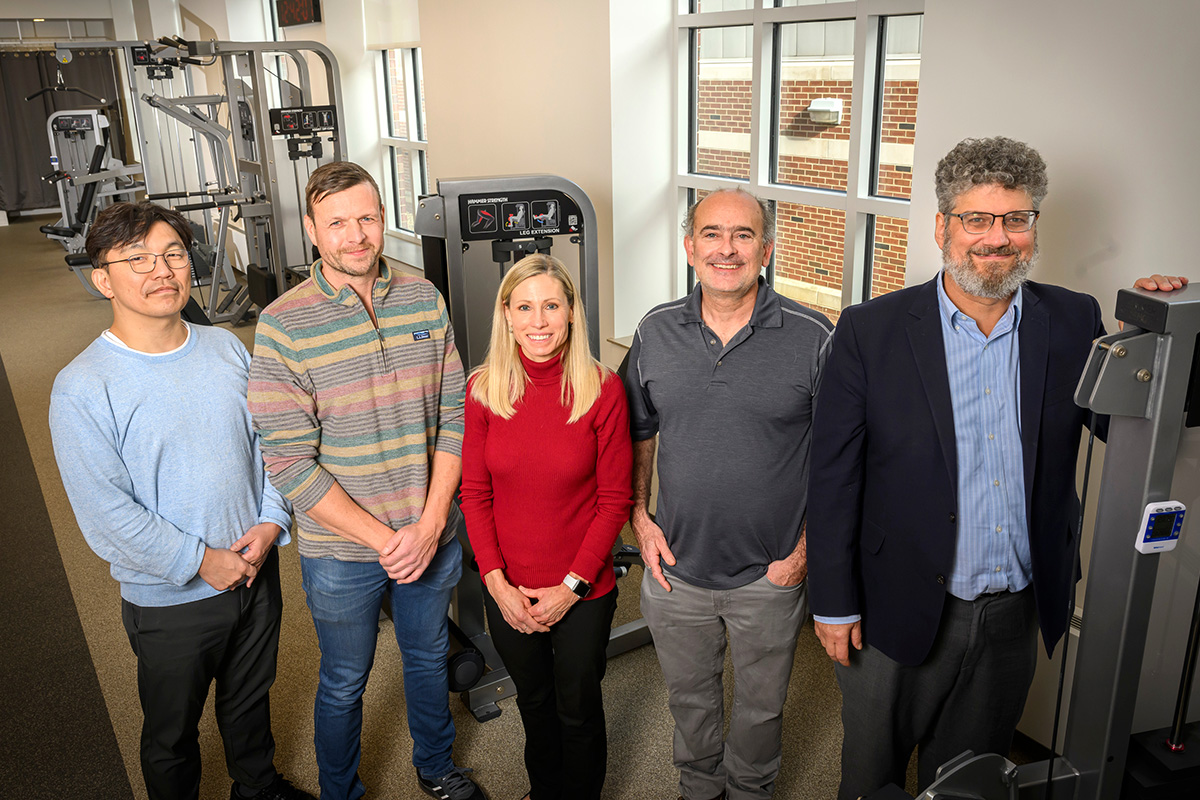 From left, chemical and biomolecular engineering professor Hyun Joon Kong, kinesiology and community health professors Nicholas Burd and Marni Boppart, psychology professor Justin Rhodes, and chemistry professor Jonathan Sweedler are gathered at the Freer Hall physical testing site at the University of Illinois Urbana-Champaign. Photo credit: Fred Zwicky.