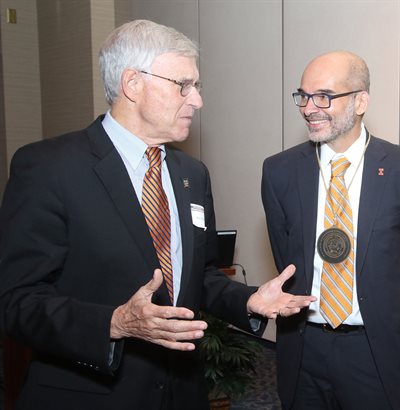 Christopher Rao, right, speaks with alumnus Ray Mentzer after the investiture ceremony on November 1, 2023.