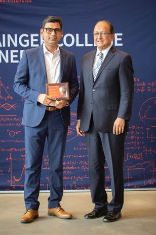 Shukla (left) received the Pierce award from the Dean of the Grainger College of Engineering, Prof. Rashid Bashir (right).